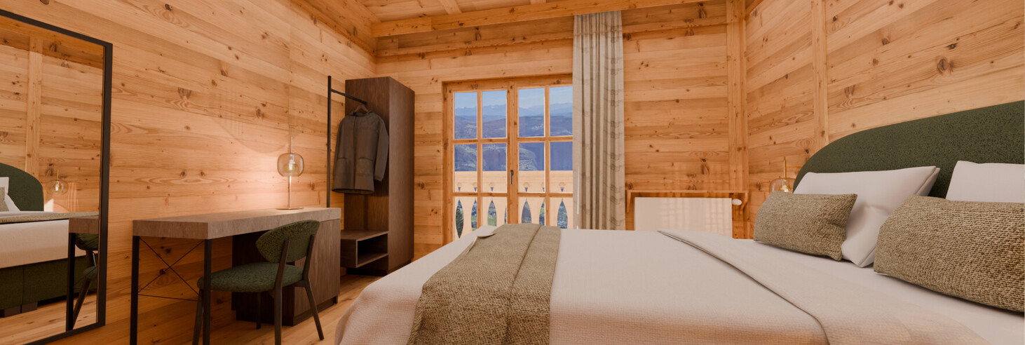 Schlafzimmer mit Holzwänden, großem Bett, Schreibtisch mit Stuhl und Fenster mit Blick auf Berge.