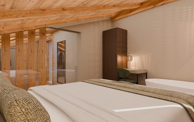 Schlafzimmer mit sichtbarer Holzbalkendecke, Doppelbett mit Kissen und Decke, freihstehende Badewanne, dunkler Schrank und grünem Stuhl vor weißer Wand.